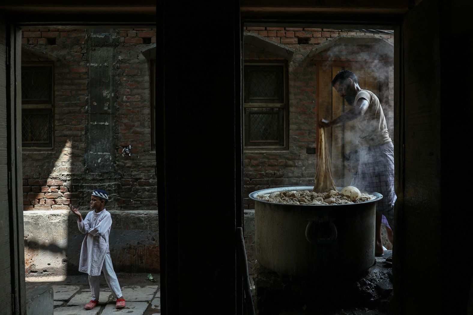 An artisan dyes a Banarasi saree at his workshop in Varanasi, India, on Saturday, June 28.