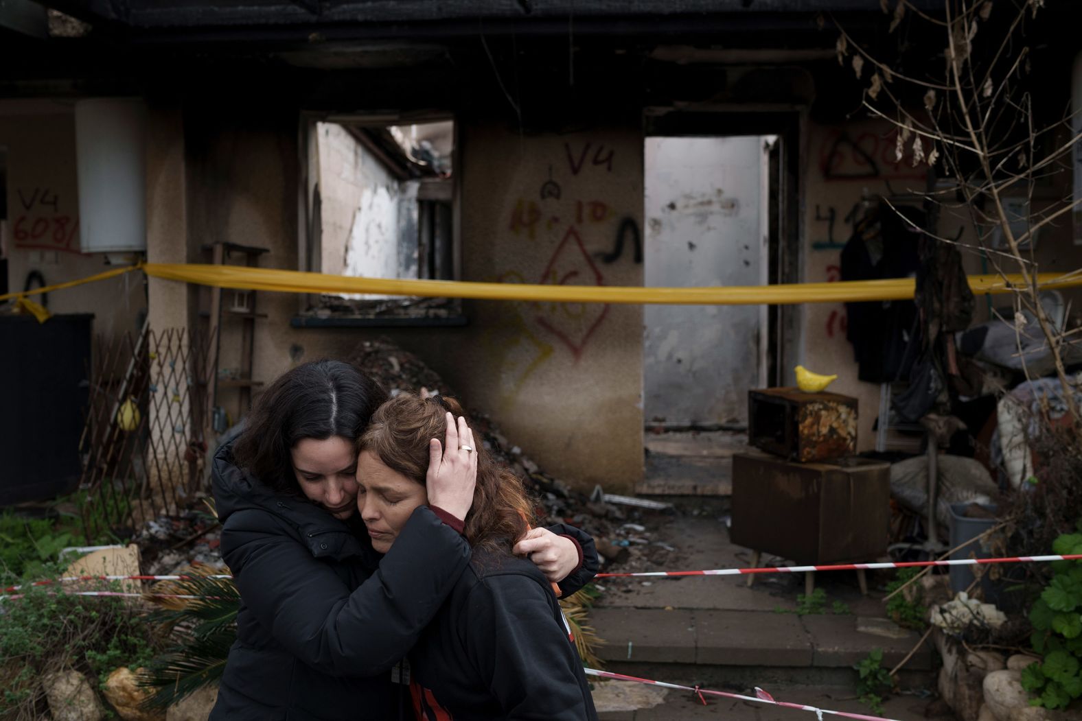 Amit Soussana, right, is embraced by a friend after speaking to journalists in front of her destroyed house in the Israeli kibbutz of Kfar Aza on January 29. <a href="https://www.cnn.com/middleeast/live-news/israel-hamas-war-gaza-news-11-30-23#h_9588a079ff958c84ba2483ed0e3f3a08">Soussana was freed by Hamas in November</a> after being taken as a hostage in October. She later became the first Israeli woman <a href="https://www.cnn.com/2024/03/26/middleeast/amit-soussana-israeli-hostage-hamas-sexual-assault-intl/index.html">to speak publicly about enduring what she says was a sexual assault and other forms of violence</a> during her 55 days in captivity.