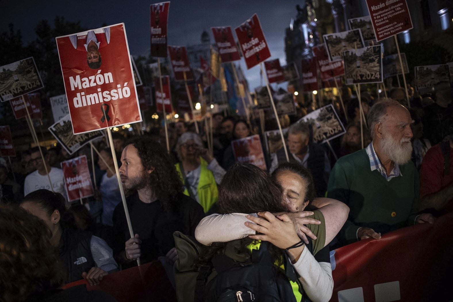 Two women embrace during a demonstration on the streets of Valencia, Spain, on Saturday, November 9. <a href="index.php?page=&url=https%3A%2F%2Fwww.cnn.com%2F2024%2F11%2F09%2Feurope%2Fvalencia-protests-spain-floods-intl-latam%2Findex.html">Tens of thousands of people marched</a> to demand the regional president resign over his response to floods that killed more than 220 people. Critics say Carlos Mazón was too slow to respond to what was the worst natural disaster the region has seen in decades. Mazón has claimed he wasn’t warned early enough about the severity of the rain by central authorities, while the Spanish government says it tried calling Mazón at least four times before being able to reach him.