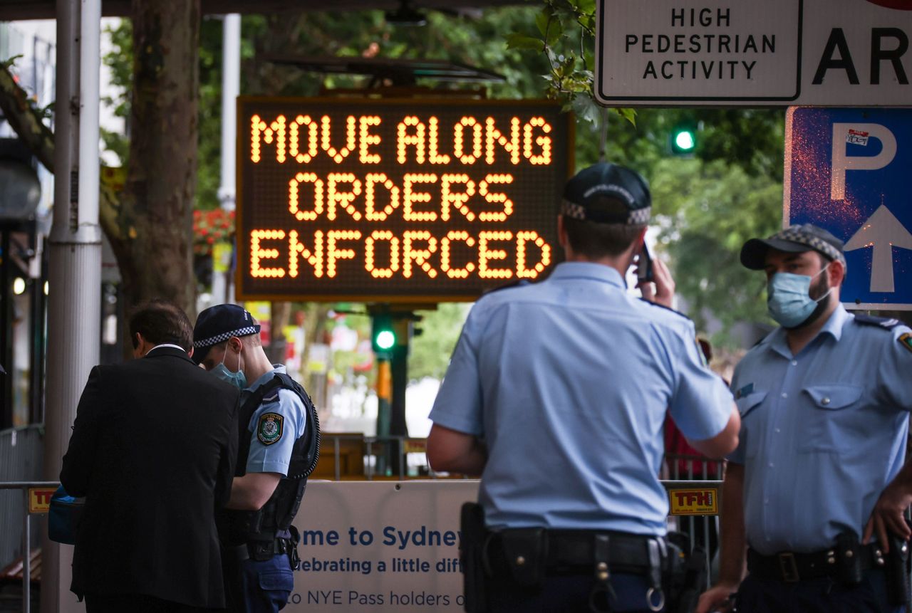 New South Wales police officers guard an entrance as part of Covid-19 restrictions for New Year celebrations around Circular Quay in Sydney on December 31. 