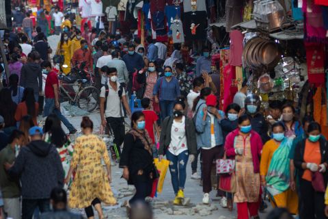 People wearing face masks as a preventive measure walk around a market in Kathmandu, Nepal, on October 9. As the Dashain festival season approaches, markets in the Nepalese capital are getting busy and crowded.