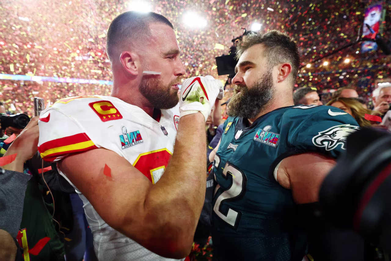 Kansas City Chiefs tight end Travis Kelce talks with his brother Philadelphia Eagles center Jason Kelce after Super Bowl LVII.
