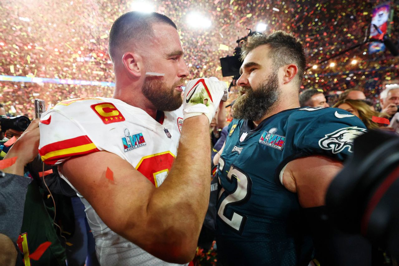 Kansas City Chiefs tight end Travis Kelce talks with his brother Philadelphia Eagles center Jason Kelce after Super Bowl LVII.