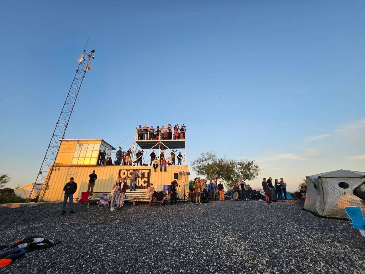 Crowds of SpaceX fans gathered at "The Outpost," a viewing site for the launch available to guests of the nearby Rocket Ranch. The "Don't Panic" sign is a reference to Douglas Adams' famed book "The Hitchhiker's Guide to the Galaxy." SpaceX has also used the reference.