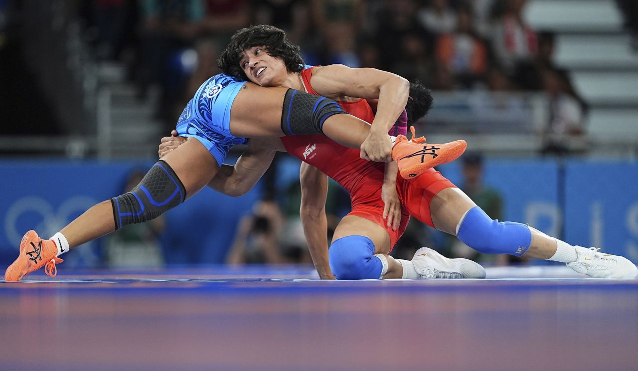 Yusneylis Guzman Lopez (blue) of Team Cuba competes against Vinesh Phogat of Team India during the wrestling - women's freestyle 50kg semifinal at the Champ de Mars Arena on August 6.