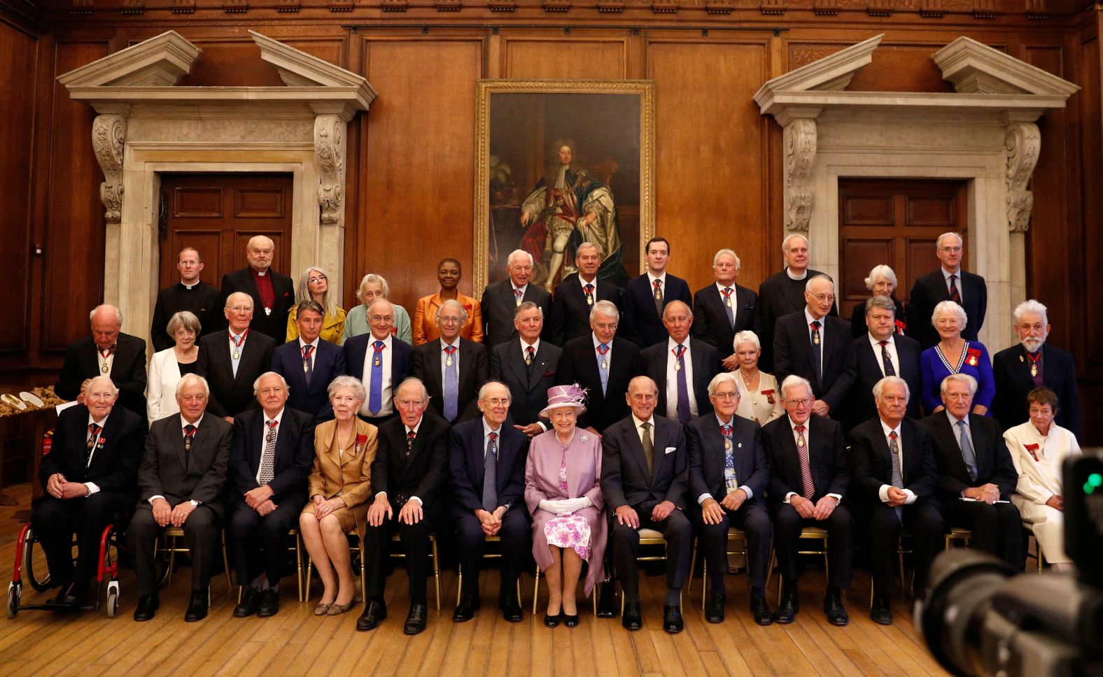 Smith, second from left in the middle row, attends an Order of the Companions of Honour celebration with Queen Elizabeth II and Prince Philip in London in 2017.