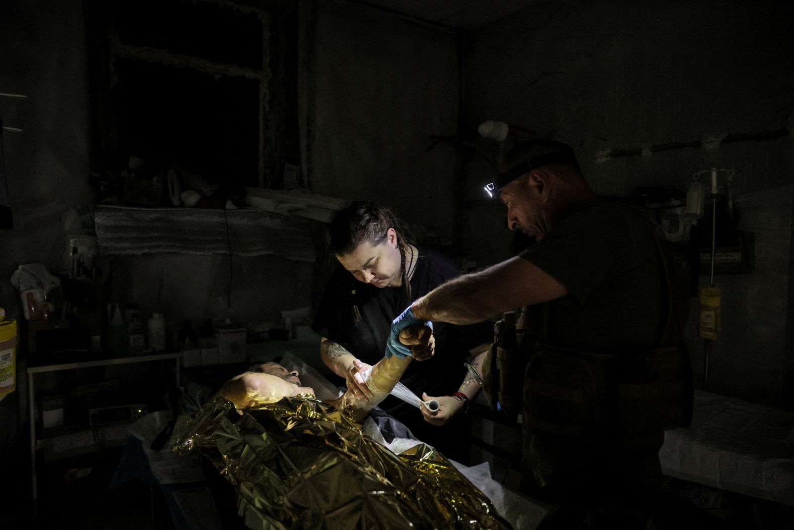Ukrainian combat medics treat an injured serviceman near the frontline town of Chasiv Yar, Ukraine, on Friday, July 25.