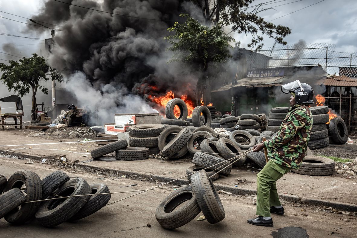 A police officer removes tires blocking a main road during clashes with protesters in Nairobi, Kenya, on Monday, July 7. At least 31 people died and more than 500 were arrested in <a  target="_top" href="/newspapers?url=https://www.cnn.com/2025/07/07/africa/kenya-police-prodemocracy-protests-intl">anti-government protests across Kenya</a> on Monday, the Kenya National Commission on Human Rights said in a statement on Tuesday.