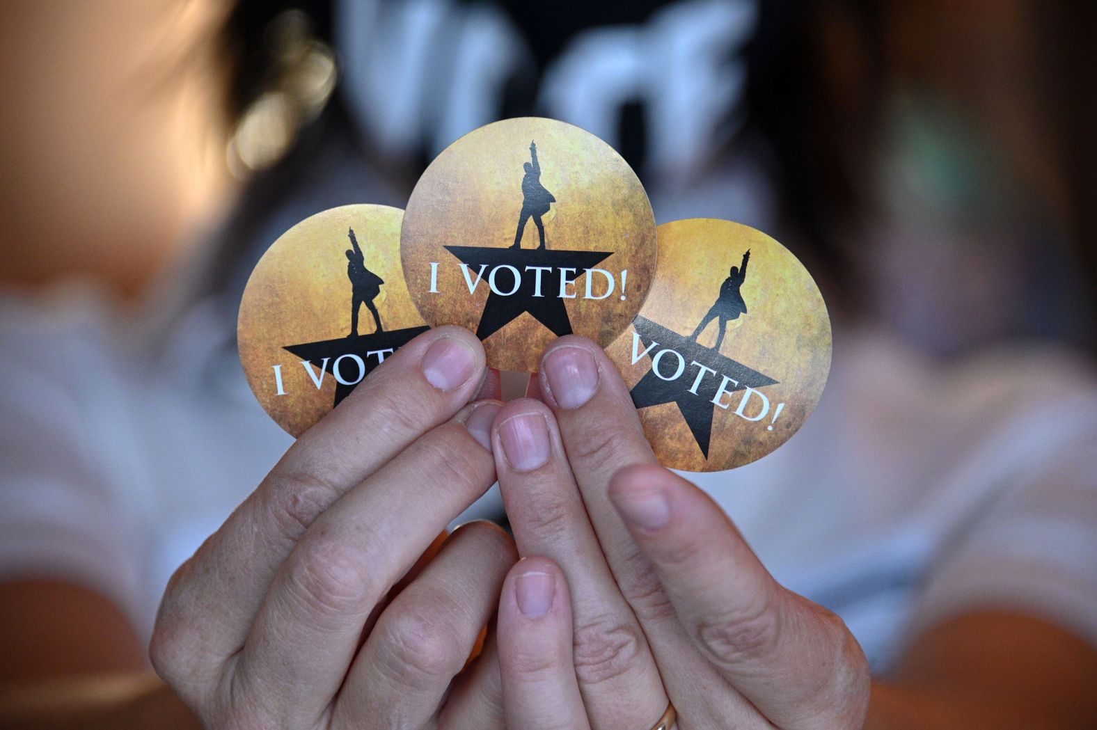 An election worker displays "Hamilton"-themed "I Voted" stickers in Hollywood in October 2020.