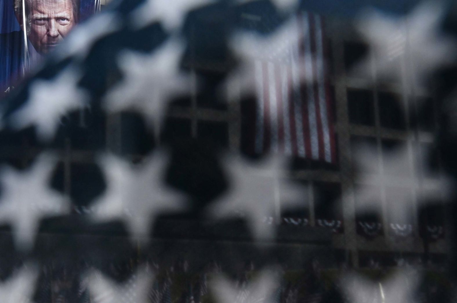 A flag frames a banner with an image of US President Donald Trump hanging at the Department of Labor in Washington, DC, on Monday, September 1. <a href="index.php?page=&url=https%3A%2F%2Fwww.cnn.com%2F2025%2F08%2F28%2Fworld%2Fgallery%2Fphotos-this-week-august-21-august-28">See last week in 32 photos</a>.