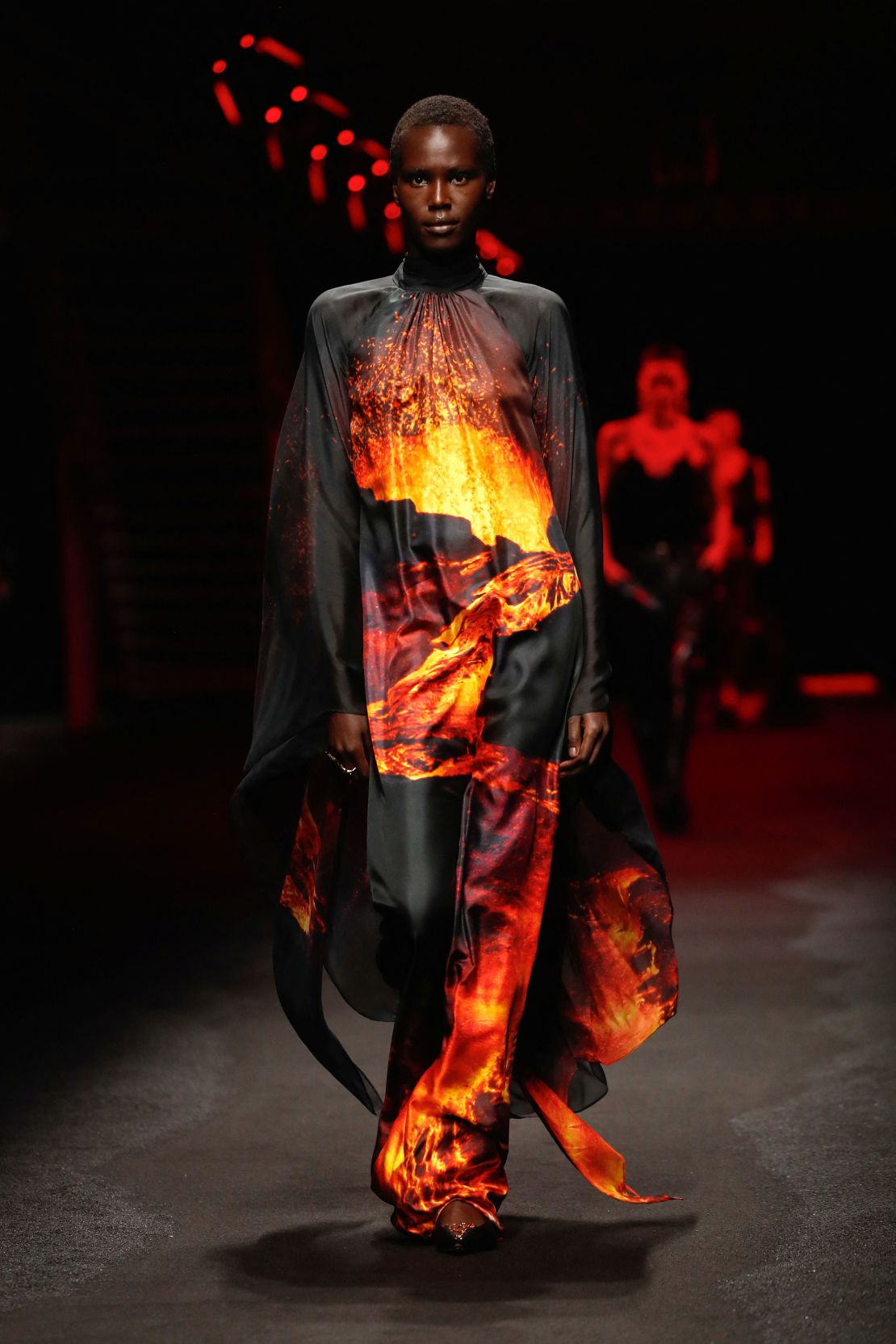 Roberto Cavalli's Fall-Winter 2025 show was comprised of elegant separates and dresses, as well as eye-catching looks like a fiery floor-length gown.