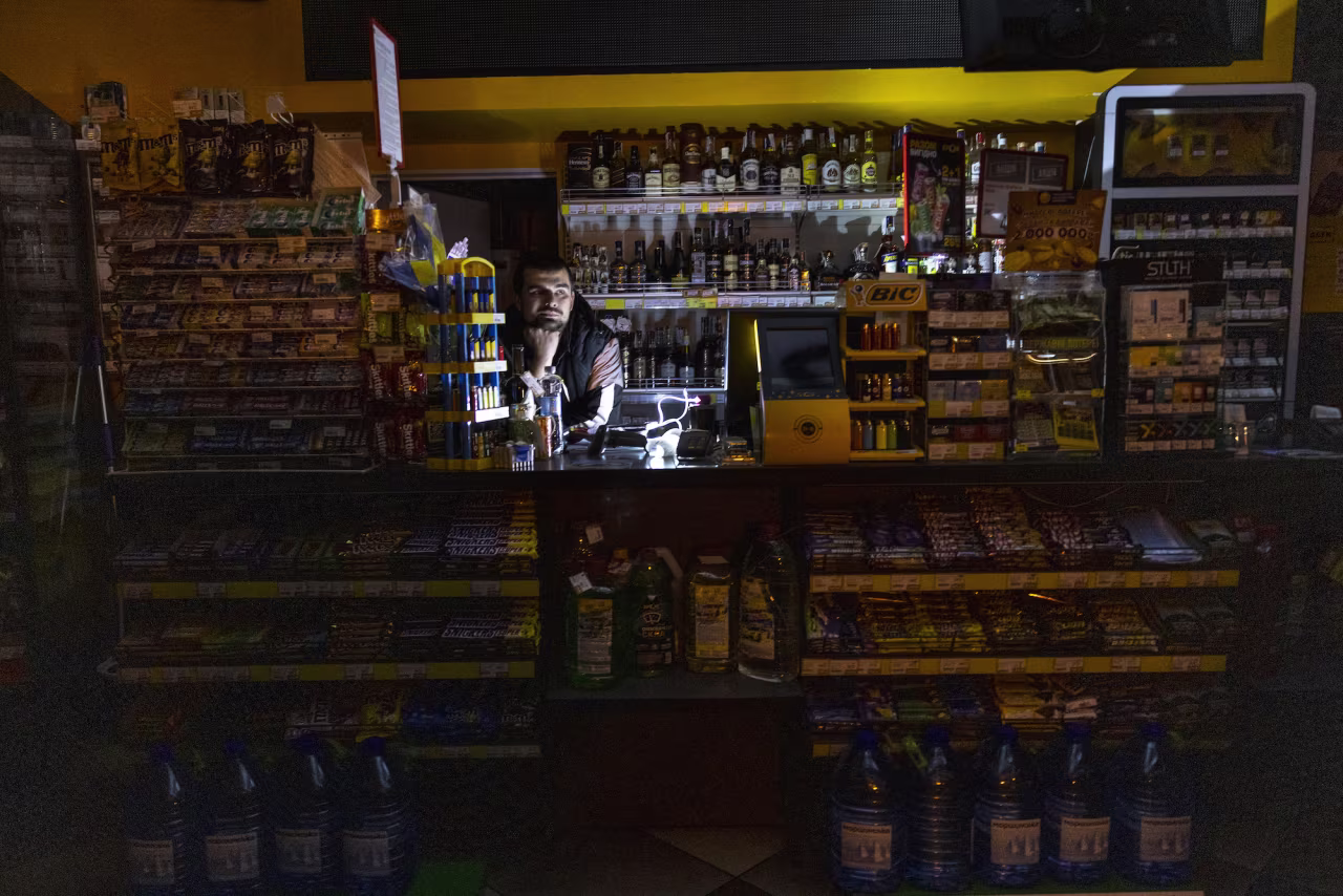 A gas station employee in Kyiv during a power outage on Friday in Kyiv.