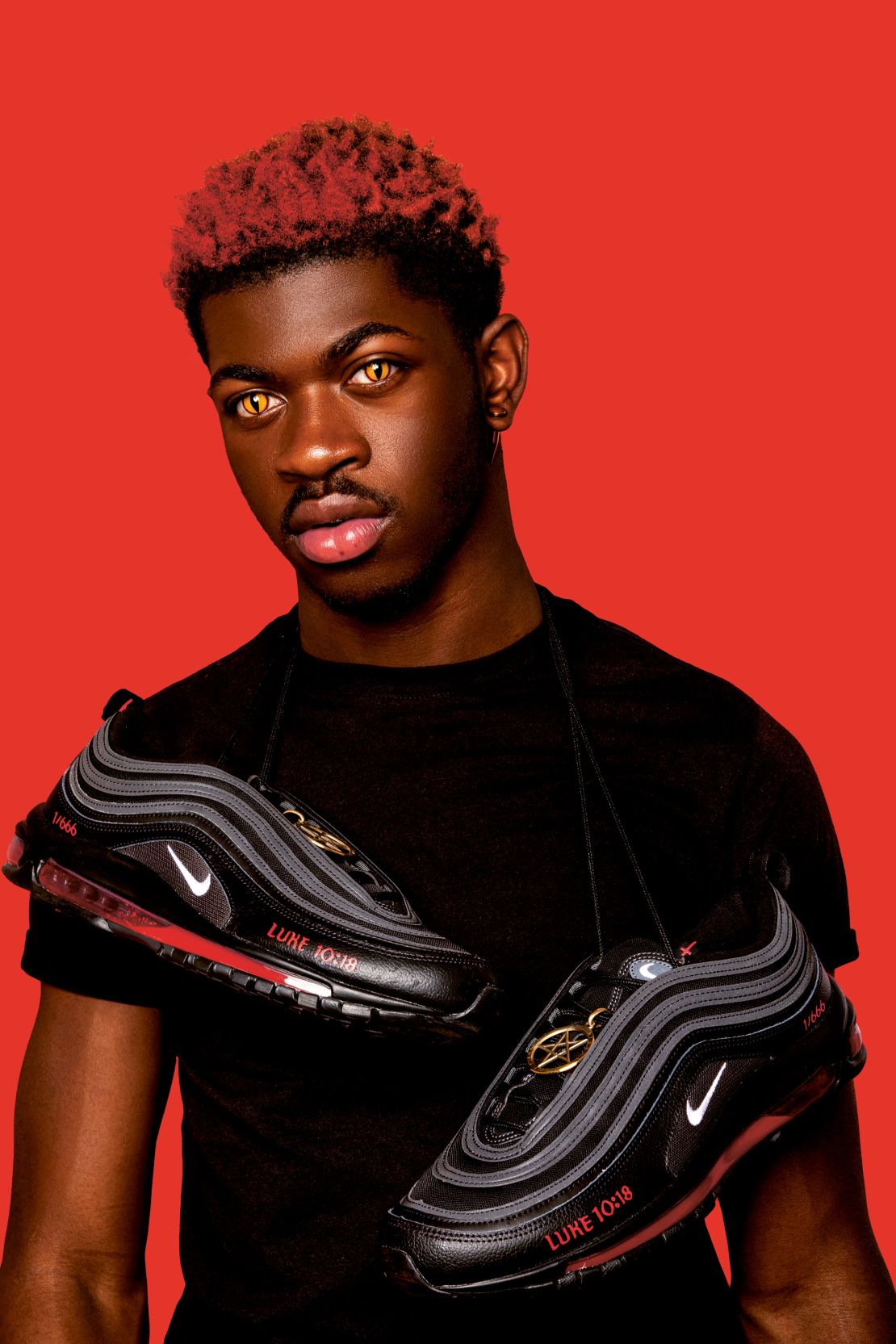 Lil Nas X with MSCHF's modified Nike Air Max 97 sneakers, which contained drops of human blood injected into the soles. Nike was not involved in the project and later filed a lawsuit against the group.