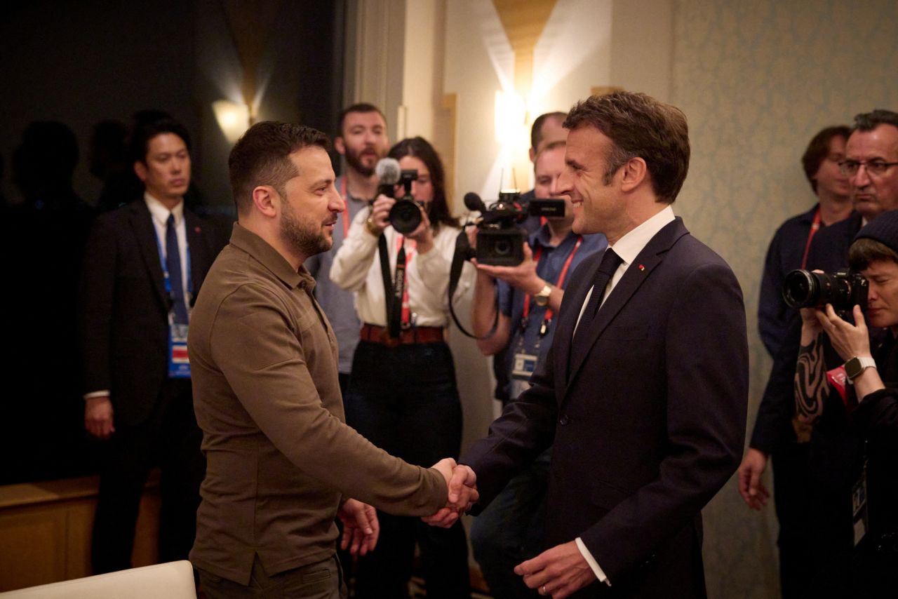 Volodymyr Zelensky and Emmanuel?Macron?shake hands during the G7 summit in Hiroshima on Saturday.