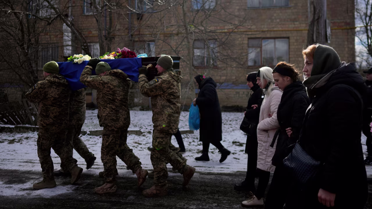 Ukrainian soldiers carry the coffin of paratrooper Vladyslav Bondarenko during his funeral in Kozyntsi, Ukraine, on Monday. Bondarenko, 26, died near Bakhmut on February 26.