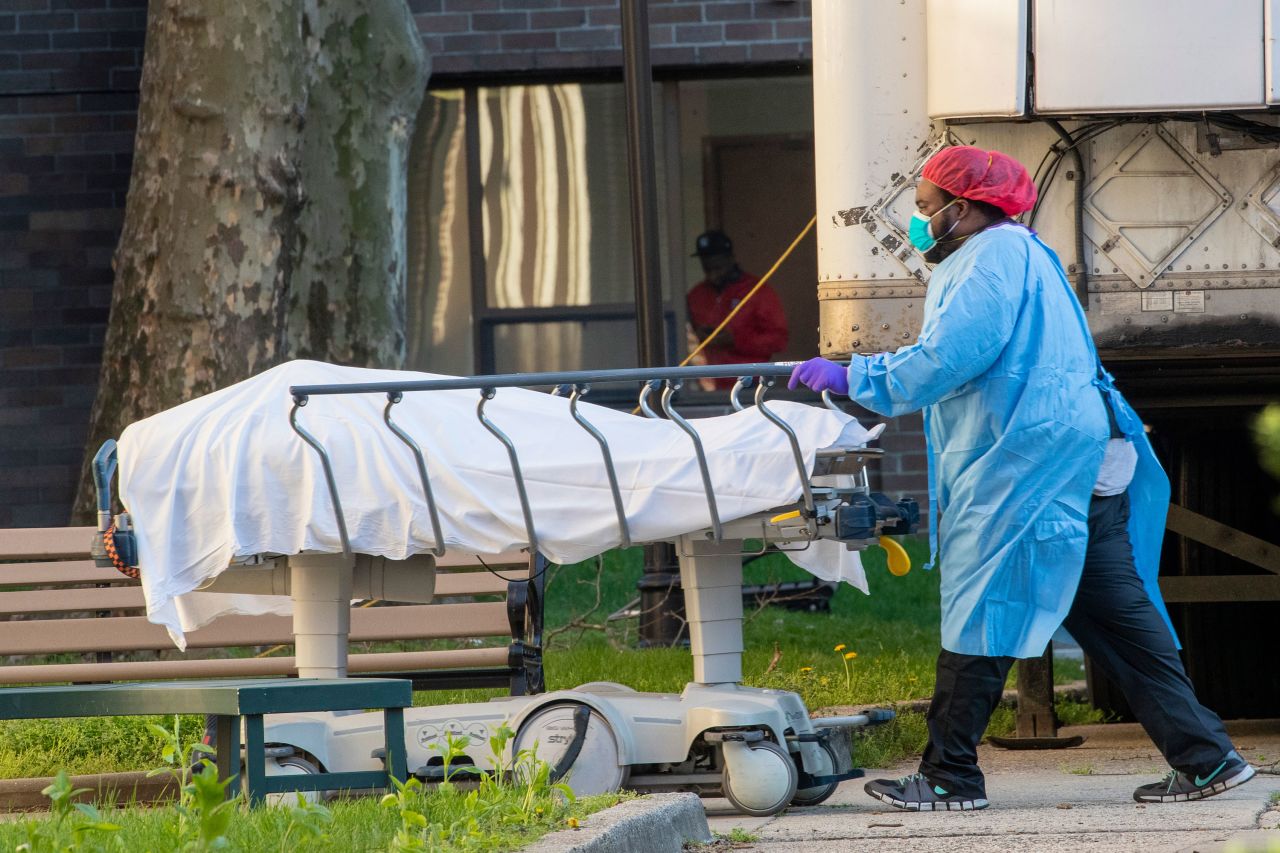 Medical personnel transport a body from a refrigerated container at Kingsbrook Jewish Medical Center, in the Brooklyn borough of New York on April 8.