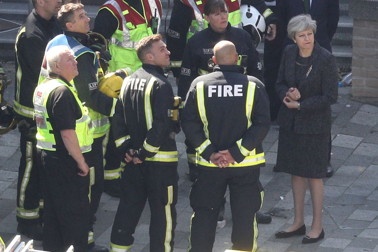 May meets with firefighters after the Grenfell Tower fire -- but her initial failure to meet survivors prompted criticism.