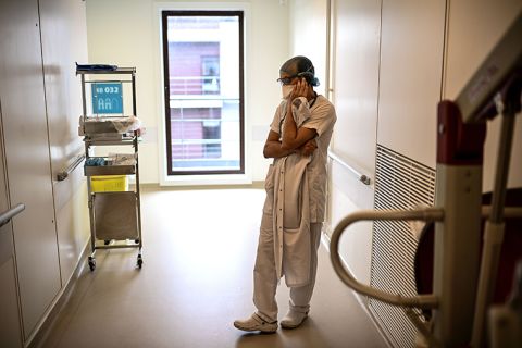 A doctor makes a phone call in a corridor of the infectious diseases unit of the Gonesse hospital before visiting a patient in Gonesse, north of Paris, on October 22, 2020.