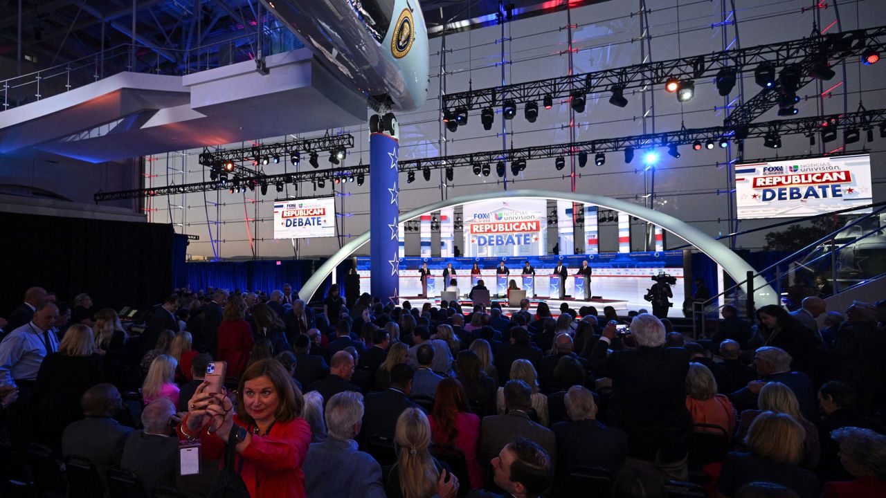 A woman takes a selfie with the candidates.