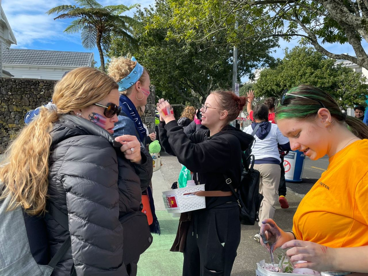 Fans get their faces painted in team colors.