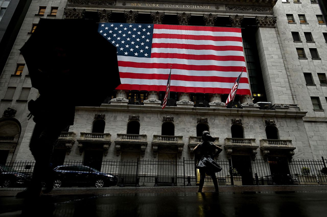 A woman walks past the New York Stock Exchange on March 19.