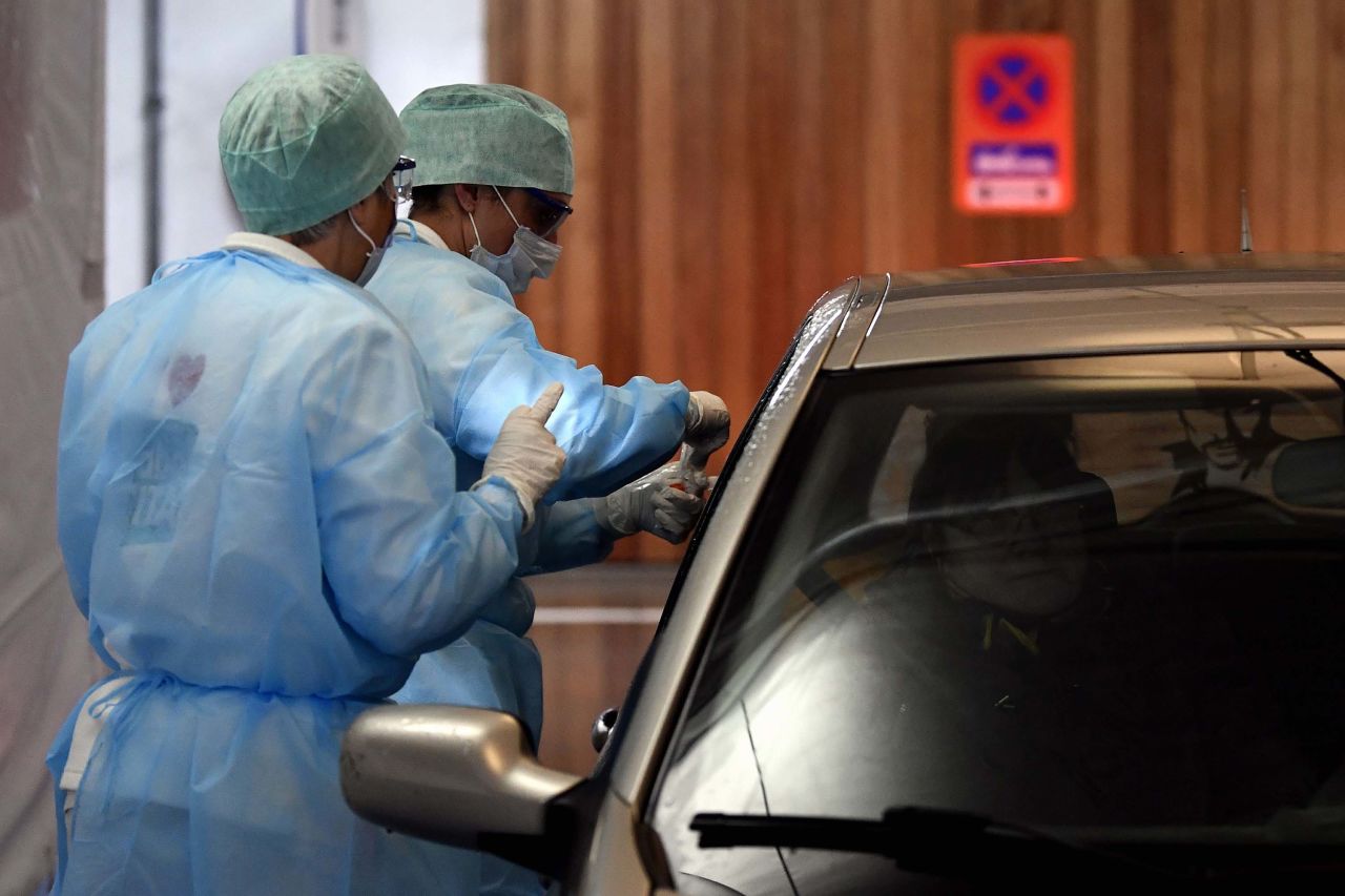 Medical staff take samples from a driver at a drive-through coronavirus testing facility, at hospital in Liege, Belgium, on Tuesday.