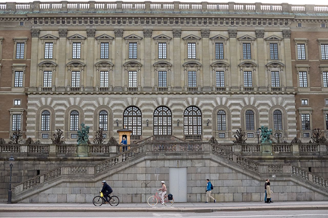 People pass by the Royal Palace in Stockholm, Sweden, on Wednesday, April 8. Swedish authorities have advised the public to practice social distancing because of the coronavirus pandemic, but still allow a large amount of personal freedom, unlike most other European countries. 