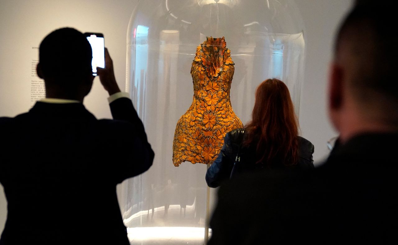 People take photos of clothing on display during a press preview of the Met Costume Institute's spring 2024 exhibition "Sleeping Beauties: Reawakening Fashion" on May 6. 