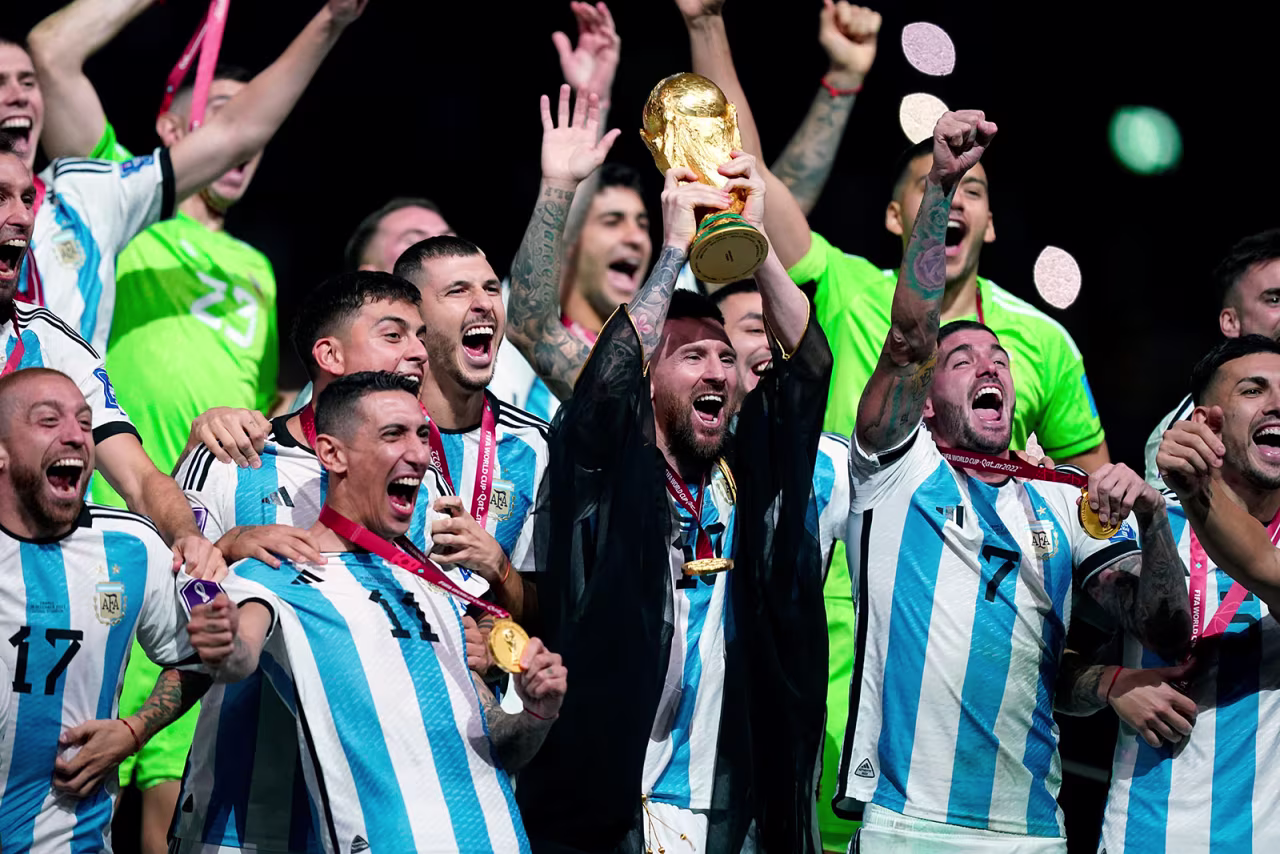 Lionel Messi lifts the FIFA World Cup trophy with his teammates following their victory over France in the final match at Lusail Stadium on Sunday. 