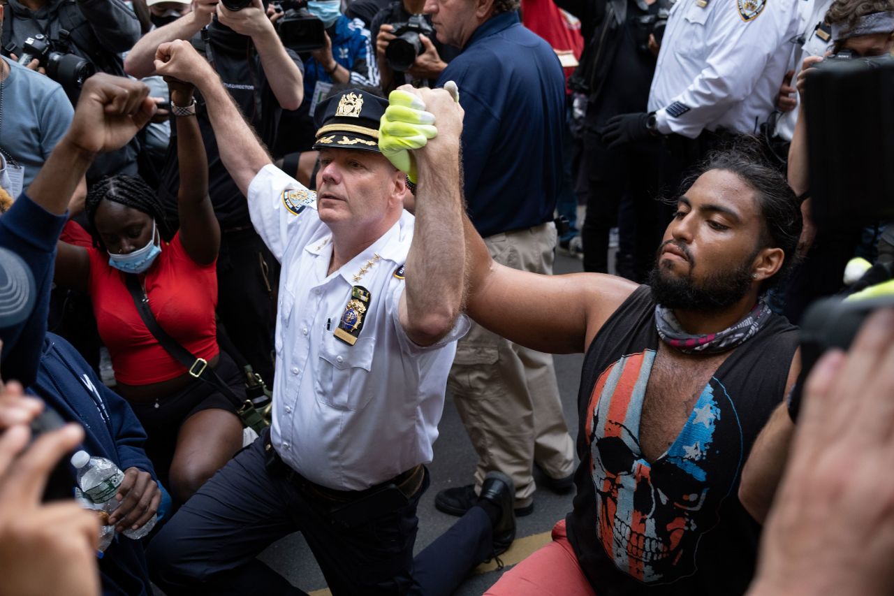 New York Police Department Chief Terence Monahan takes a knee with protesters on Monday in New York.