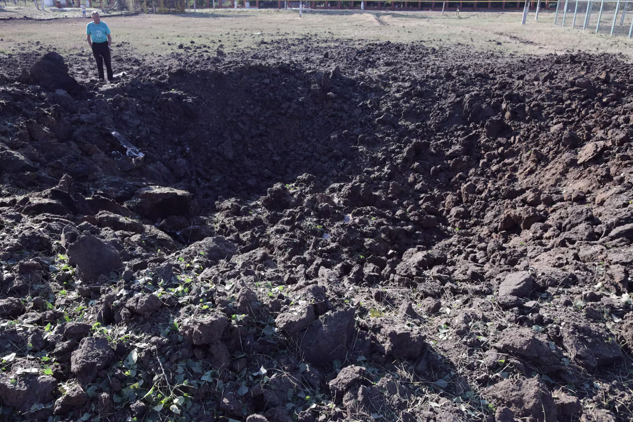 A man stands in front of a crater following a Russian airstrike in a village in the Odesa region, Ukraine, on July 19.