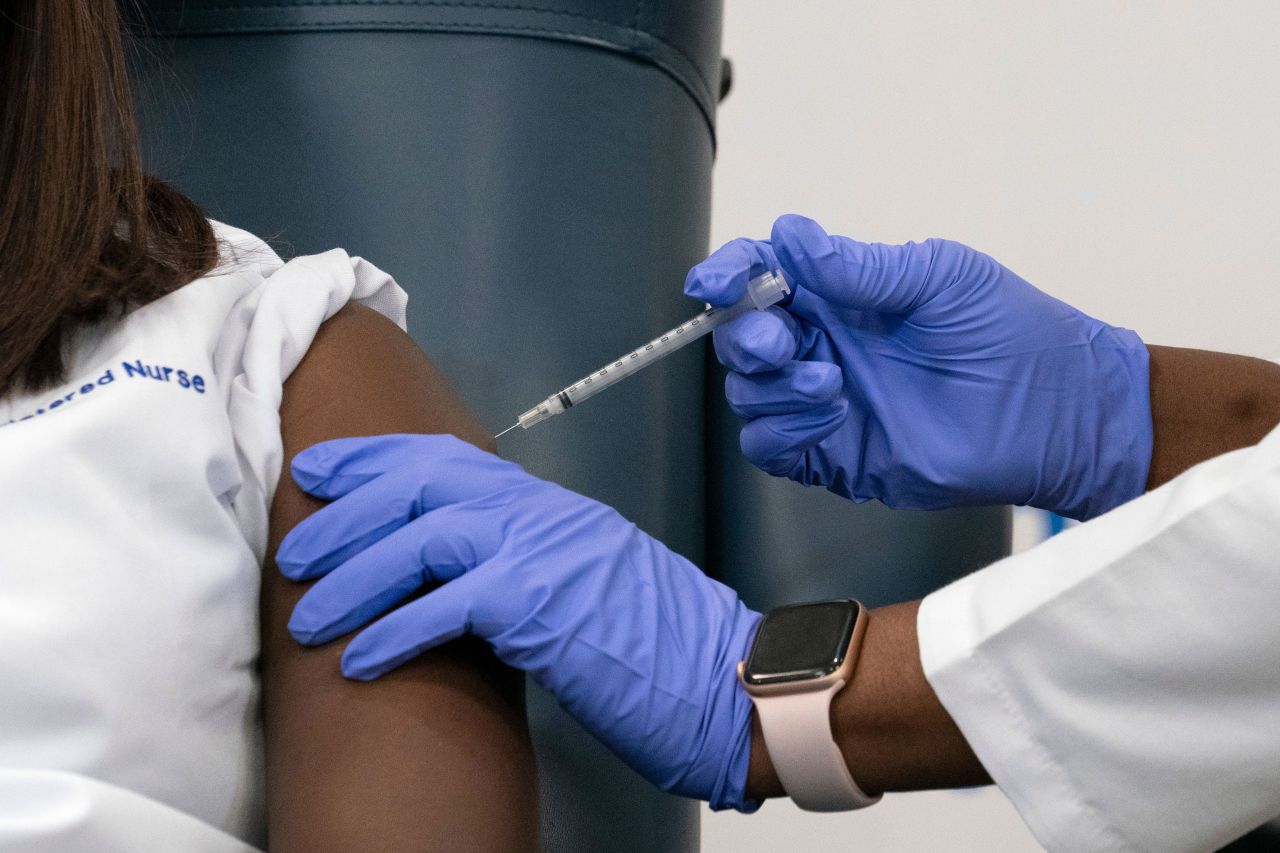 Sandra Lindsay, a nurse at Long Island Jewish Medical Center, is inoculated with the Pfizer-BioNTech Covid-19 vaccine by Dr. Michelle Chester in Queens, New York, on December 14.