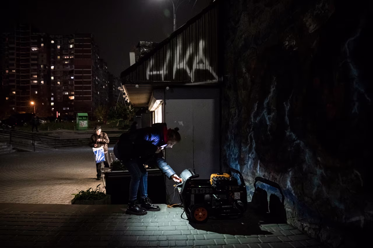 A woman looks at generator that powers a cafe in Kyiv on November 05.