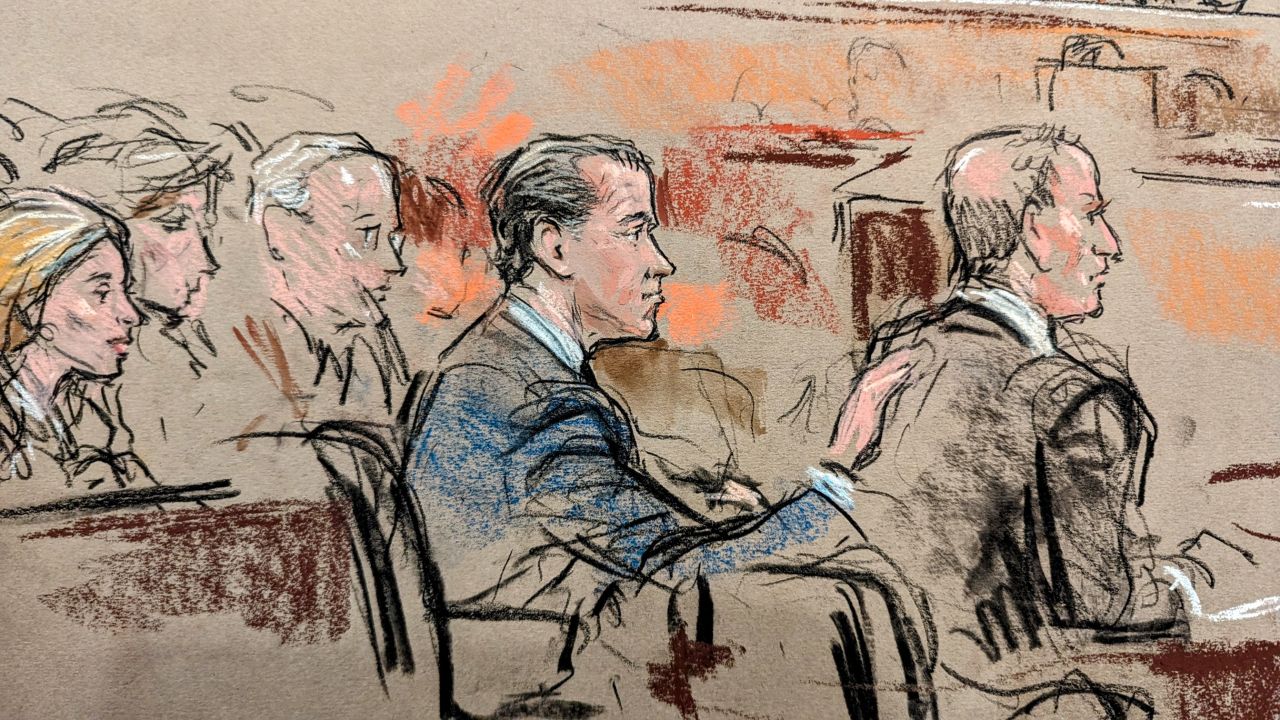 Hunter Biden places his hand on the shoulder of his attorney Abbe Lowell as the verdict is read during his trial in Wilmington, Delaware, on June 11, 2024.