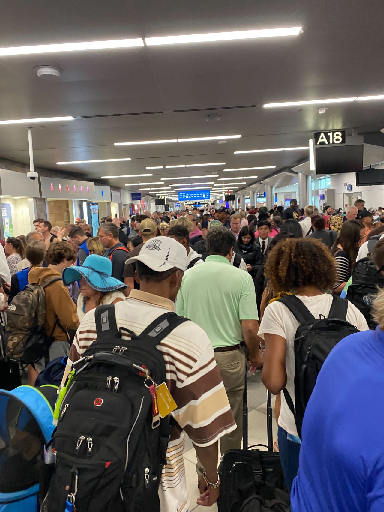 People are seen at Hartsfield-Jackson Atlanta International Airport during a technology outage on July 19.