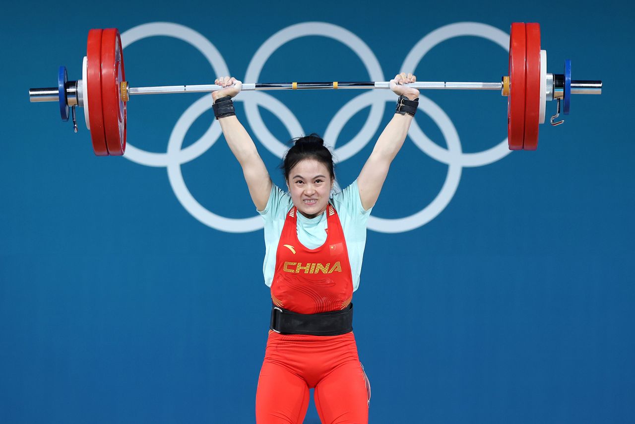 Luo Shifang of Team People's Republic of China performs a clean & jerk to set new Olympic Record of 134kg during the Weightlifting Women's 59kg at South Paris Arena on August 8.