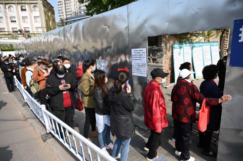 People line up to be vaccinated against Covid-19 outside a residential compound in Beijing, on April 8.
