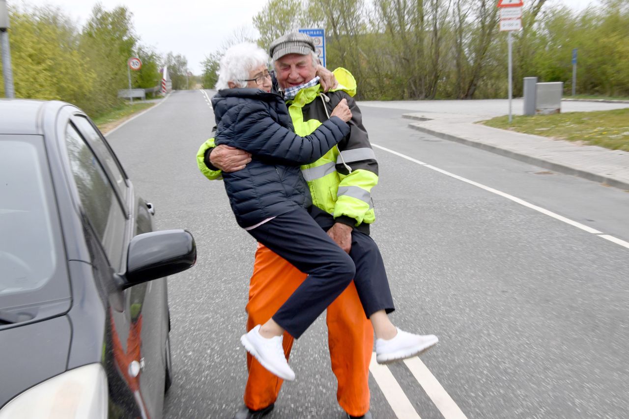 Inga Rasmussen, left, from Denmark is lifted up by Karsten Tüchsen Hansen from North Frisia during their daily meeting at the German-Danish border on April 24. 