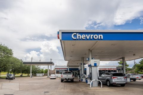 Cars parked at Chevron gas station pumps are seen on July 29 in Houston, Texas.