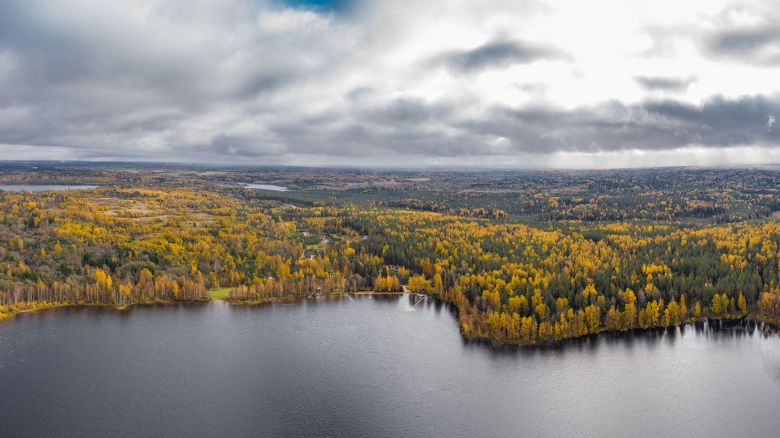 2BE47GM Drone view point of Wooden boat bath on a lake, water area in Autumn with lake Boroye, Valday national park, Russia, panoramic image, golden trees