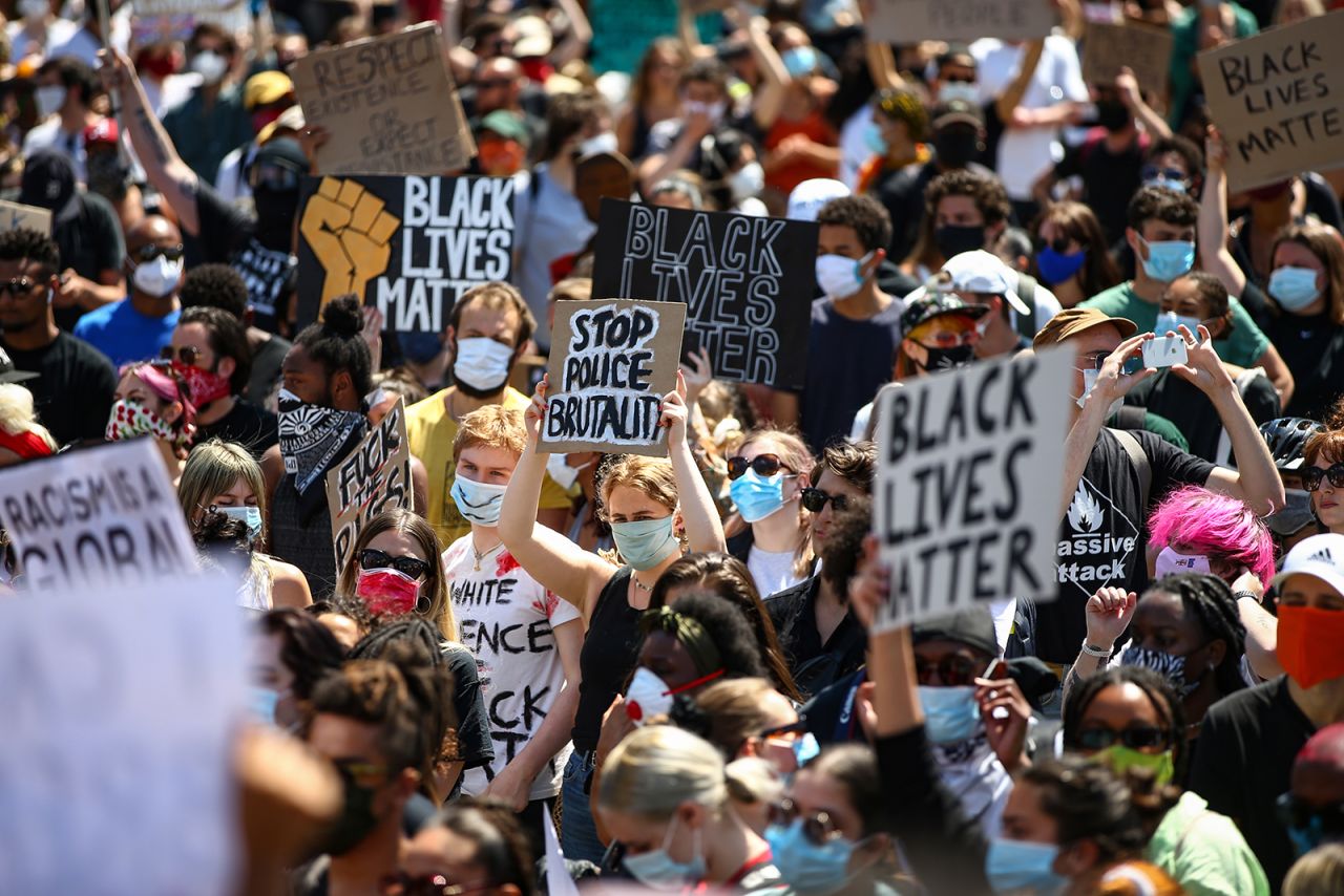 People hold placards as they join a spontaneous Black Lives Matter march at Trafalgar Square to protest the death of George Floyd in Minneapolis and in support of the demonstrations in North America on May 31, in London.