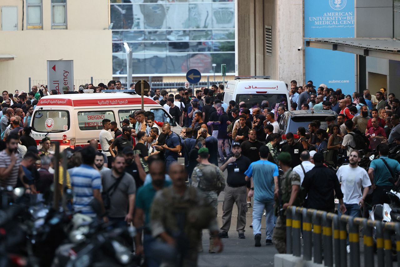 Ambulances are surrounded by people at the entrance of the American University of Beirut Medical Center, on September 17, after paging devices exploded simultaneously across Lebanon. 