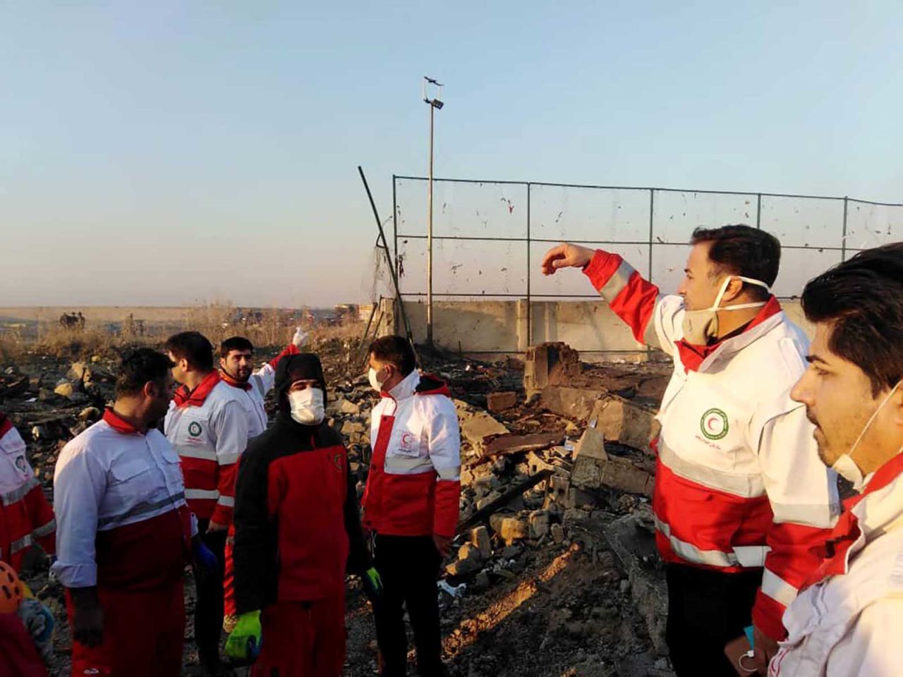 Search and rescue workers coordinate at the crash site.