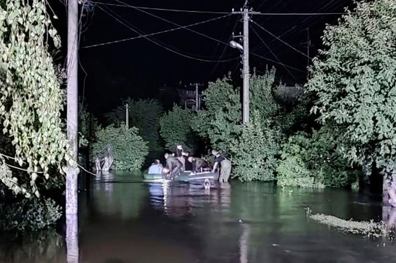 Rescuers evacuate people from a flooded area after a Russian missile hit a hydraulic structure in Kryvyi Rih on September 14.