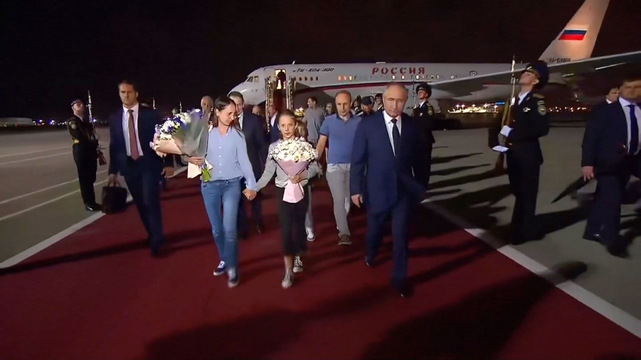 Russian president Vladimir Putin receives the Russian citizens released in the prisoner swap as they disembarked the plane upon arrival in Moscow from Ankara on Thursday, August 1.