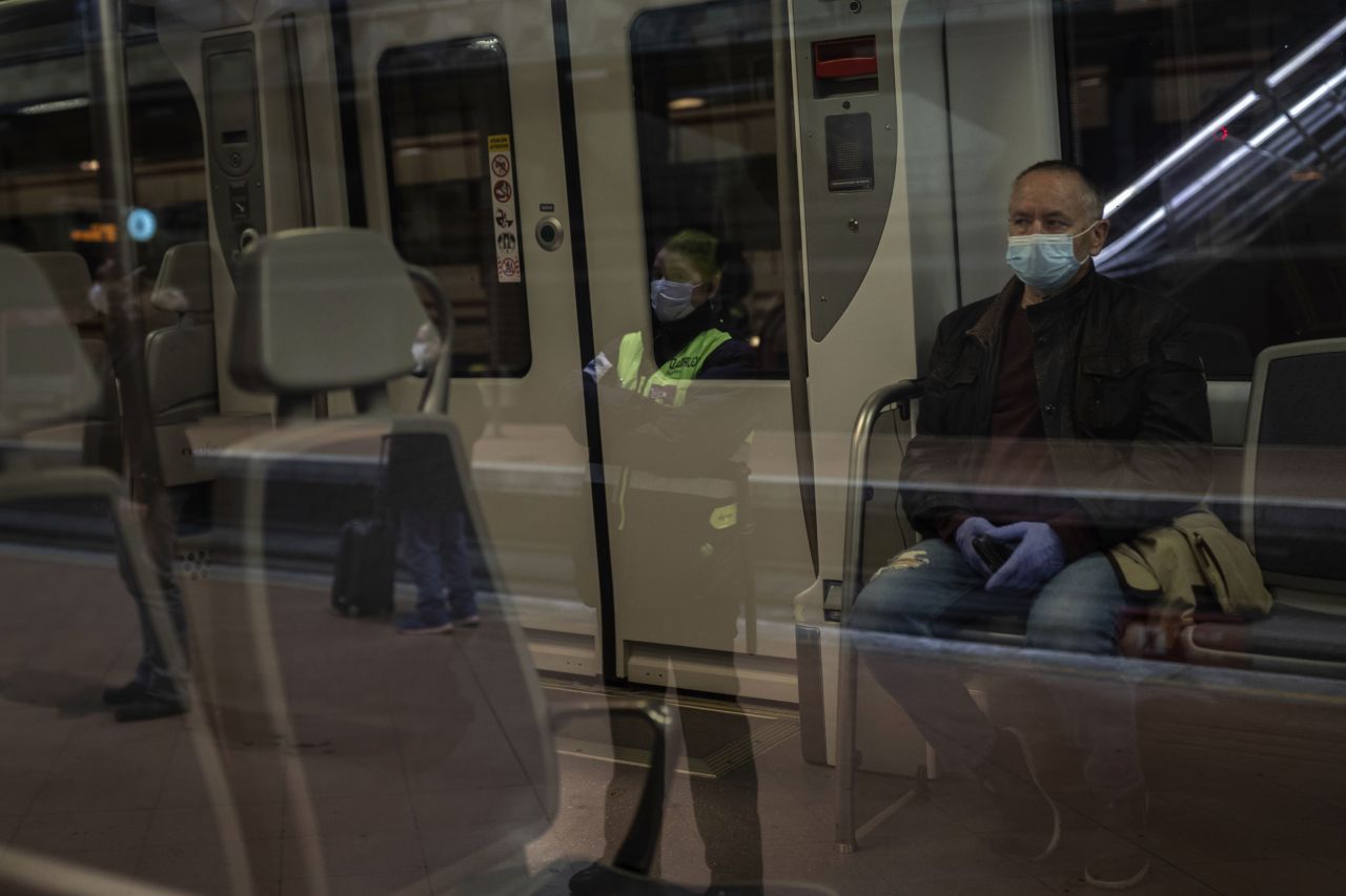 Commuters wear face masks at Atocha train station in Madrid on April 13.