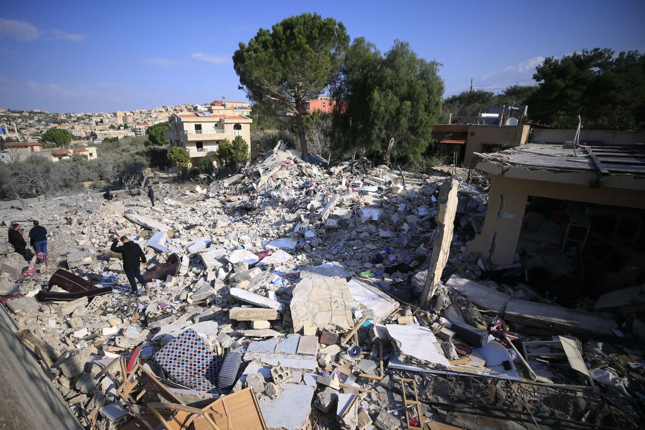 People check rubble from the damage of an Israeli airstrike in southern Lebanon on Wednesday.