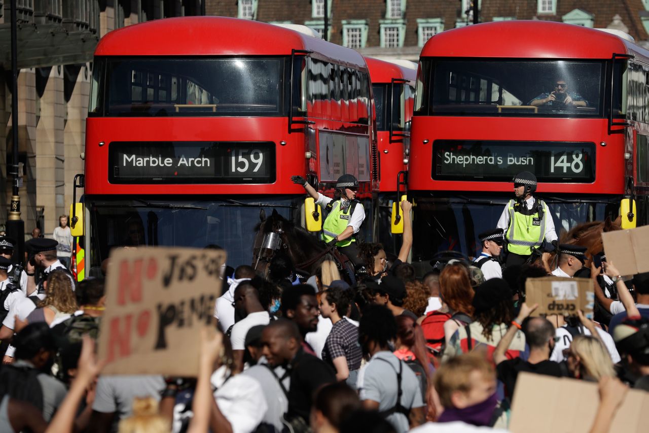 Police officers on horseback monitor demonstrators blocking the road outside the Houses of Parliament in central London on Sunday, May 31.