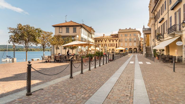 Arona, Piedmont, Italy - September 25, 2019: View of Central square - Piazza Del Popolo with traditional bars, restaurants and shops in center of Arona, located on the shore of Lake Maggiore in Piedmont, Italy