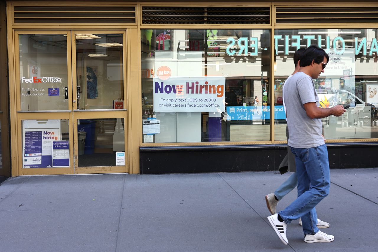 A "Now Hiring" sign is seen at a FedEx location on Broadway on June 7 in New York City. 